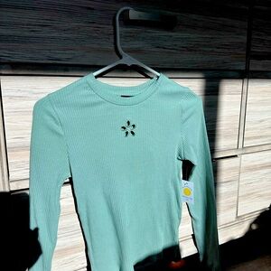 This is a light green long sleeve top